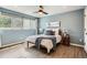 Bright bedroom with a large window, wood floors, and soothing blue walls at 5150 Buckingham Rd, Boulder, CO 80301
