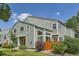 Charming townhome exterior with mature landscaping, a quaint fence, and a pop of color from the front door at 5150 Buckingham Rd, Boulder, CO 80301