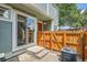 Charming front entrance with a small patio, wooden fence, and visible house number on the door at 5150 Buckingham Rd, Boulder, CO 80301