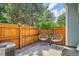 Cozy patio area with a wooden fence, comfortable seating, and lush greenery, ideal for relaxing at 5150 Buckingham Rd, Boulder, CO 80301