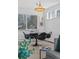 Dining area with mid-century modern table and chairs at 2490 S Lima St, Aurora, CO 80014