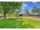 Expansive backyard featuring a lush lawn and mature trees, perfect for outdoor activities and relaxation at 485 S Pierson St, Lakewood, CO 80226