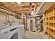 Unfinished basement laundry room with visible utilities, washer, dryer and storage at 485 S Pierson St, Lakewood, CO 80226