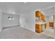 Finished basement space with new gray carpet, built-in wet bar area, and a window at 485 S Pierson St, Lakewood, CO 80226