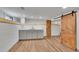 Finished basement featuring a stylish kitchenette and rustic sliding barn doors at 485 S Pierson St, Lakewood, CO 80226