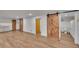 Finished basement featuring modern flooring, stylish barn doors, and a bathroom at 485 S Pierson St, Lakewood, CO 80226