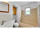 Vintage bathroom featuring a sink, toilet, bathtub with a shower, and a window at 485 S Pierson St, Lakewood, CO 80226