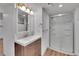 Renovated bathroom with a modern vanity, updated lighting, and glass walk-in shower at 485 S Pierson St, Lakewood, CO 80226