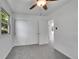 Bright bedroom features neutral carpet, white walls, ceiling fan, and closet at 485 S Pierson St, Lakewood, CO 80226
