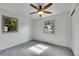 Sunlit bedroom featuring new gray carpeting, two windows, and a ceiling fan at 485 S Pierson St, Lakewood, CO 80226