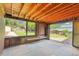 Covered back patio with stone tiled floor, wood ceiling and scenic backyard views at 485 S Pierson St, Lakewood, CO 80226