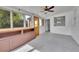 Bright sunroom with large windows, ceiling fan, built-in shelves, and new carpet at 485 S Pierson St, Lakewood, CO 80226