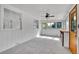 Bright sunroom features light walls, many windows, and new carpet at 485 S Pierson St, Lakewood, CO 80226
