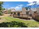 Well-maintained backyard features a deck, lush green lawn, and space for outdoor entertaining at 14139 W Warren Dr, Lakewood, CO 80228