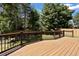 Expansive backyard deck perfect for entertaining, surrounded by mature trees and fencing at 14139 W Warren Dr, Lakewood, CO 80228