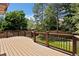 Large wooden deck surrounded by lush greenery, creating a private outdoor oasis at 14139 W Warren Dr, Lakewood, CO 80228
