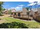 Charming backyard view featuring a well-kept lawn and a wooden deck perfect for outdoor living at 14139 W Warren Dr, Lakewood, CO 80228