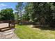 Beautifully landscaped backyard with a spacious lawn, deck, and privacy fence for outdoor enjoyment at 14139 W Warren Dr, Lakewood, CO 80228
