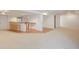 Large open finished basement featuring a kitchenette, ample carpeted living space, and extra storage at 14139 W Warren Dr, Lakewood, CO 80228
