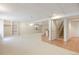 Open finished basement with bar area, built in shelving, access to the staircase, and comfortable carpet at 14139 W Warren Dr, Lakewood, CO 80228