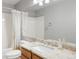 Bathroom with a shower-tub, granite vanity, and bright lighting at 14139 W Warren Dr, Lakewood, CO 80228
