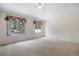 Bright bedroom with neutral carpet, ceiling fan and two windows that provide lots of natural light at 14139 W Warren Dr, Lakewood, CO 80228
