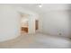 Bedroom featuring plush carpeting and convenient access to an ensuite bathroom with traditional wooden cabinets at 14139 W Warren Dr, Lakewood, CO 80228