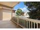 Cozy covered porch providing shade and view of the landscaped front yard and quiet street at 14139 W Warren Dr, Lakewood, CO 80228