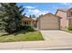 Charming home with a well-manicured lawn, mature trees, and a two-car garage at 14139 W Warren Dr, Lakewood, CO 80228