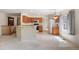 Open kitchen with island, granite counters, wood cabinets and modern appliances at 14139 W Warren Dr, Lakewood, CO 80228