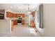 Spacious kitchen with white appliances, natural wood cabinets, and a large window for natural light at 14139 W Warren Dr, Lakewood, CO 80228