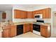 Modern kitchen with stainless steel appliances, granite countertops, and natural wood cabinetry at 14139 W Warren Dr, Lakewood, CO 80228