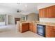 Kitchen with granite countertops, natural wood cabinets, and opening into the living area with a fireplace at 14139 W Warren Dr, Lakewood, CO 80228