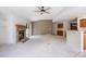 Open living room with a fireplace, neutral carpet, and a sliding door to the backyard at 14139 W Warren Dr, Lakewood, CO 80228