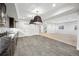 Open basement featuring tile flooring, a kitchenette, and access to the upper levels at 1131 S York St, Denver, CO 80210