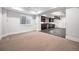 Finished basement with carpeted living area and tiled kitchenette, perfect for entertaining at 1131 S York St, Denver, CO 80210