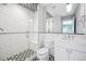 Stylish bathroom with a glass shower, white tile, and black and white patterned floor at 1131 S York St, Denver, CO 80210