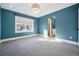 This spacious bedroom has a walk-in closet, large windows, and soft carpeting at 1131 S York St, Denver, CO 80210