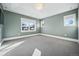 Spacious bedroom with plush carpet, tray ceiling, and plenty of light from bright windows at 1131 S York St, Denver, CO 80210