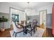 Elegant dining room featuring a chandelier, stylish seating, and seamless flow into other living spaces at 1131 S York St, Denver, CO 80210