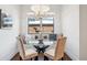 Breakfast nook features a chandelier, built-in bench seating, and a glass table under a window at 1131 S York St, Denver, CO 80210