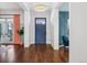 Welcoming foyer showcasing hardwood floors, a stylish light fixture, and a pop of color with pink curtains at 1131 S York St, Denver, CO 80210