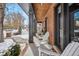 Inviting front porch with white chairs and brick flooring, snowy landscape at 1131 S York St, Denver, CO 80210