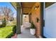 Inviting front porch with swing, brick facade, and a beautifully landscaped yard and front door at 1131 S York St, Denver, CO 80210