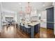 Bright, spacious kitchen with a large center island, modern appliances, pendant lighting, and hardwood floors at 1131 S York St, Denver, CO 80210