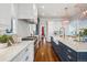 Spacious kitchen with gray island, marble countertops, stainless steel appliances, and hardwood floors at 1131 S York St, Denver, CO 80210