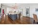 Spacious kitchen with gray island, marble countertop, farmhouse sink, hardwood floors, and modern light fixtures at 1131 S York St, Denver, CO 80210