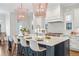 Large kitchen island with marble countertop, seating, and pendant lighting, stainless steel appliances and hardwood floors at 1131 S York St, Denver, CO 80210