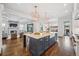 Open-concept kitchen with a center island, stainless steel appliances, and seamless flow into the living area at 1131 S York St, Denver, CO 80210