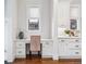 Charming kitchenette area features built-in desk, crisp white cabinets, and built-in storage at 1131 S York St, Denver, CO 80210